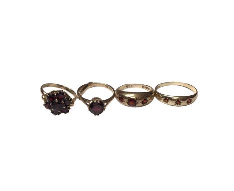 9ct gold garnet cluster ring, 9ct gold garnet single stone ring and two 9ct gold garent three stone gyspy set rings (4)Total 