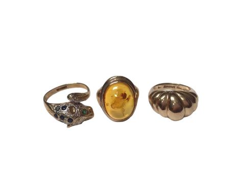 9ct gold diamond, sapphire and emerald set leopard head ring, size P½, 9ct gold polished amber ring, size J and 9ct gold 'cro