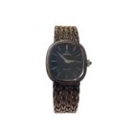 Omega De Ville ladies silver wristwatch with a navy dial and silver baton markers, on a woven silver