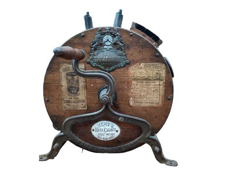 Early 20th century knife cleaner by Kent, 199 High Holborn London, with applied metal and ceramic plaques and orignal paper l