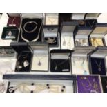 Group of silver and white metal gem set pendants on chains and other necklaces, mostly boxed