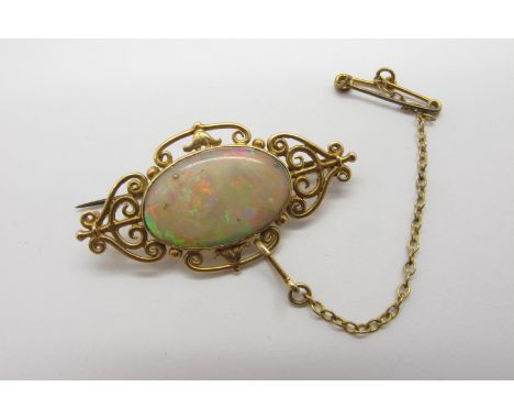 A c.Early XX Century Opal Set Brooch, oval collet set to the centre with a (19mm wide) single stone opal, within shaped scrol