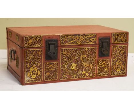 20th Century Oriental trunk having hinged cover, the red lacquer effect finish with blind fretwork gilt decorated chinoiserie