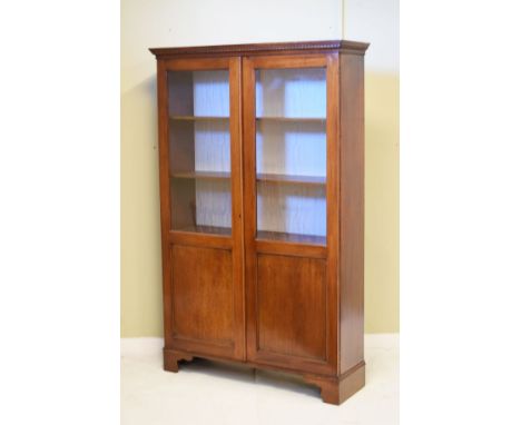 Mahogany cabinet bookcase fitted three shelves enclosed by a pair of partially glazed doors and standing on bracket feet   Co