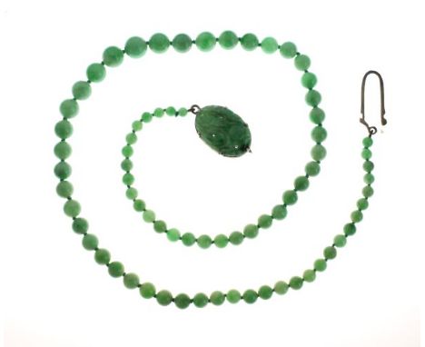 Graduated string of jade beads having a white metal carved oval jade panel mounted clasp   Condition: 