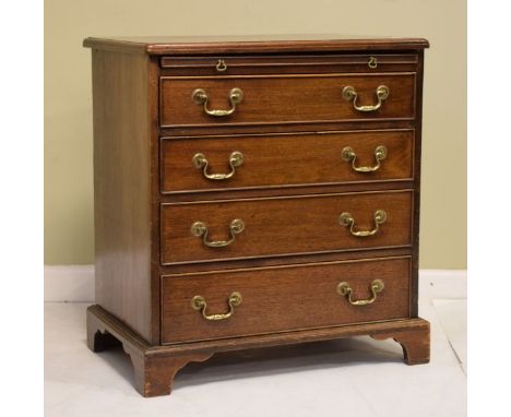 Reproduction mahogany chest fitted slide with four drawers below and standing on bracket feet   Condition: 