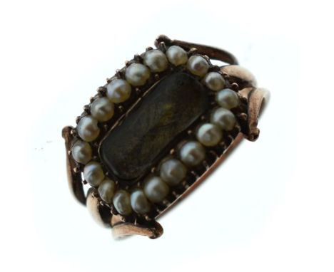 Early 19th Century gold coloured metal mourning ring having rectangular woven hair panel within a seed pearl border, with ins