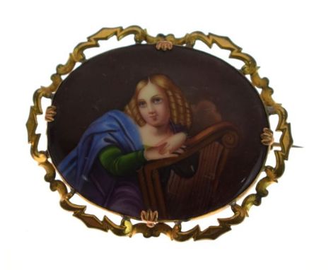 Late 19th/early 20th Century oval brooch having inset porcelain panel depicting a lady with harp, within a gilt metal border 