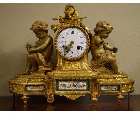 19th Century French ormolu figural cased mantel clock, the case decorated with two seated cherubs, Sevres style porcelain pan