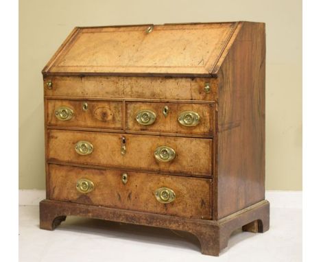 George III walnut bureau, having herringbone banding, the fall flap opening to reveal a stepped fitted interior with well, fi