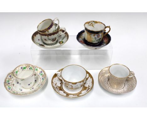 A collection of porcelain cabinet cups and saucers to include a Coalport coffee cup and saucer, Miles Mason white and gold cu
