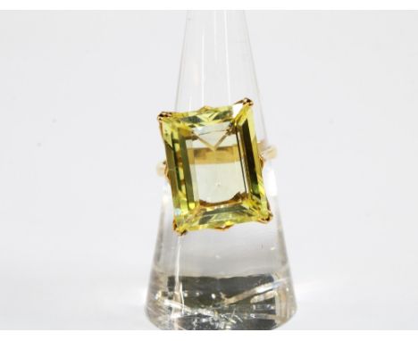 Yellow sapphire dress ring, the step cut stone is claw set in unmarked yellow metal