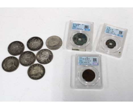 Two Chinese cash coins and another in Perspex boxes together with seven white metal coins (10) 