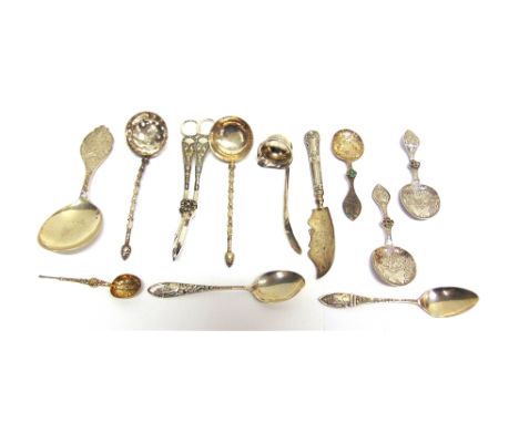 A COLLECTION OF ASSORTED FLATWARE  comprising a silver anointing spoon; a silver cream ladle; two American spoons; three East