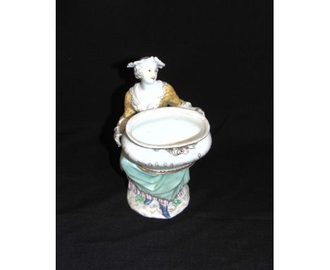 A MEISSEN FIGURAL SALT  modelled as a seated lady holding a basin, underglaze blue crossed swords mark to base, 19cm high