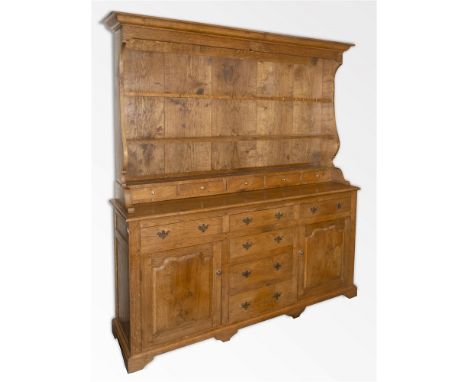 A LARGE OAK DRESSER  the Delft rack with three drawers above five spice drawers, the base with four graduated drawers flanked