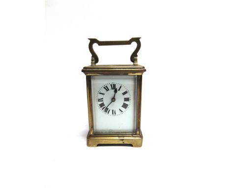 A BRASS CASED CARRIAGE CLOCK  the enamel dial with Roman numerals