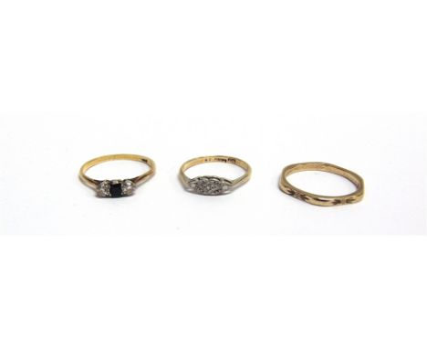 THREE GOLD RINGS  comprising; an early 20th century gold, small sapphire and diamond three stone ring, stamped '18ct';  a tin