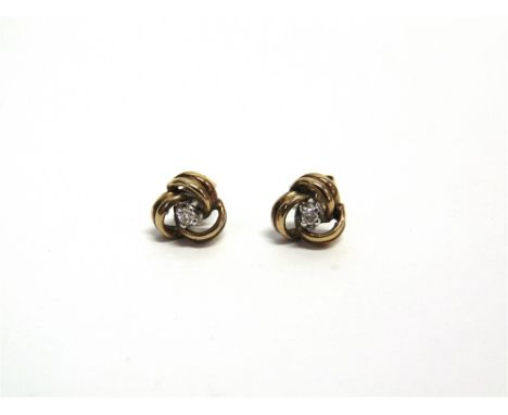 A PAIR OF GOLD AND SMALL DIAMOND KNOT STUD EARRINGS the round brilliant approximately 0.05cts, indistinct hallmarks, 2.4g gro