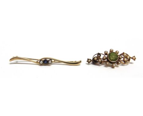 TWO EARLY 20TH CENTURY GOLD AND GEM SET BROOCHES  comprising; a peridot and half pearl open scrolling brooch, stamped '(?)5ct