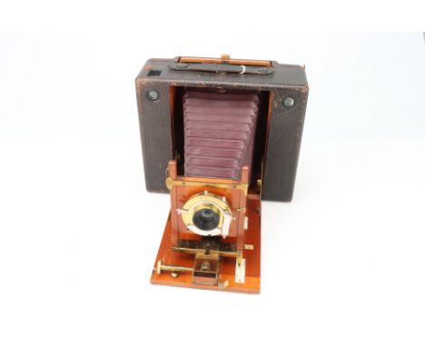A Kodak No.5 Cartridge Camera, leather-covered mahogany, body G, shutter working, optics G, some fungus present,