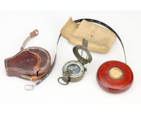 Surveying Instruments, an army marching prismatic magnetic compass, by Stanley, in leather case, with a Chesterman 50 foot ru