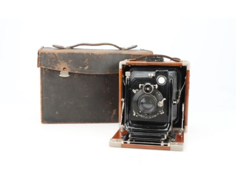 An ICA Dresden Tropical Folding Plate Camera, mahogany &amp; brass, body G, focussing rack requires attention, ground glass u