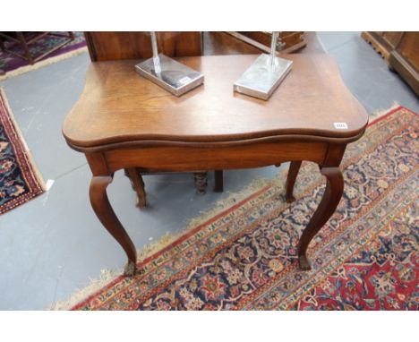 AN EARLY 19TH.C.COLONIAL HARDWOOD FOLD OVER CARD TABLE ON CARVED CABRIOLE LEGS