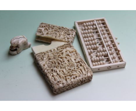 A CHINESE CARVED IVORY CARD CASE, A CHINESE CARD IVORY ABACUS AND A NETSUKE (3)