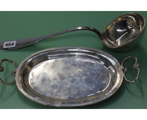 AN 18TH/19TH CENTURY CONTINENTAL SILVER COLOURED SOUP LADLE BEARING ARMORIAL, AND A TWO HANDLED OVAL TRAY, 30 X 17CM.