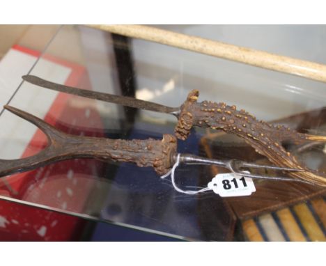 AN ANTIQUE ANTLER MOUNTED KNIFE AND FORK.
