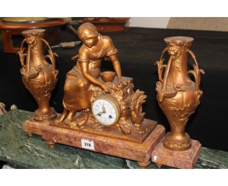 AN ART NOUVEAU CLOCK GARNITURE. FIGURAL CAST METAL CASE ON MARBLE PLINTH. FRENCH STRIKING MOVEMENT WITH ENAMELLED DIAL