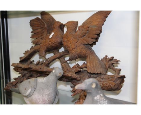 A CARVED BLACK FOREST PIPE RACK, THREE PIGEON DECOYS AND VARIOUS GAME AND TRIBAL ARTIFACTS.