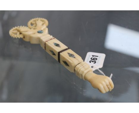 A LARGE SAILOR MADE MARINE IVORY TWIN WHEELED CRIMPER? FIST FORM FINIAL. MOTHER OF PEARL AND DIAMOND INSERTS