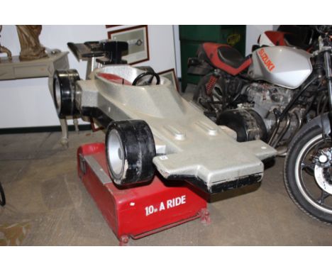 A VINTAGE ELECTRIC CHILD'S ROCKING RACE CAR