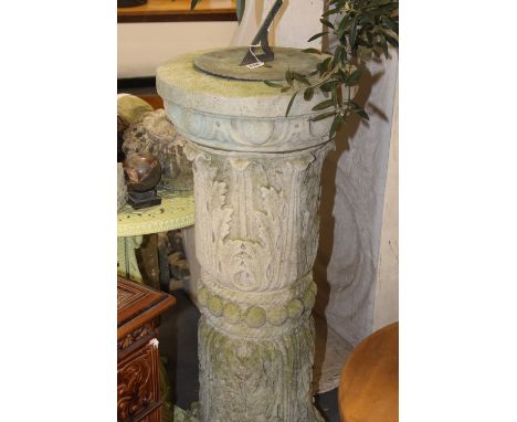 A WEATHERED CARVED GARDEN SUNDIAL WITH ACANTHUS LEAF DECORATION