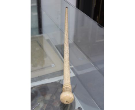 AN ANTIQUE WHALEBONE AND MARINE IVORY WALKING STICK. SIMPLE TAPERED SHAFT WITH TURNED HANDLE. LENGTH 81cms