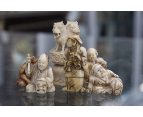 A LATE 19TH CENTURY BONE CARVED CANE FINIAL IN THE FORM OF A FOUR HEADED LION AND FIVE NETSUKE (6)