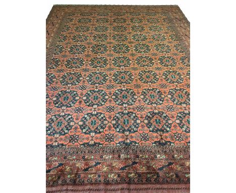 FINE AFGHAN BASHIR CARPET, 395cm x 300cm, of multiple medallions in sapphire and ruby.