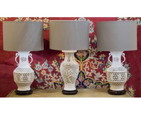 LAMPS, a set of three, reticulated white ceramic Chinese vase form, tallest 65cm H. (3) (one with faults)