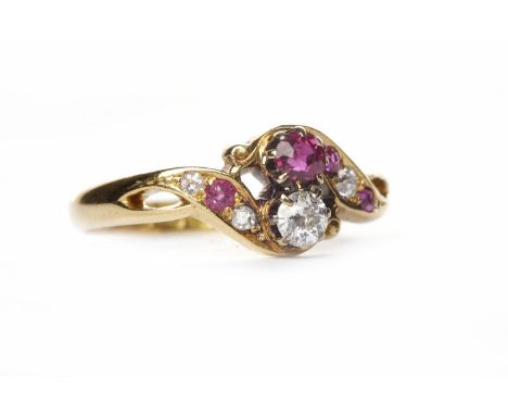 DIAMOND AND RUBY DRESS RINGset with a principal round brilliant cut diamond and ruby, in a twist setting, on ruby and diamond