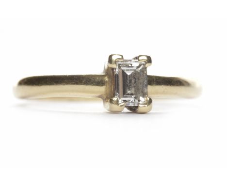 DIAMOND SOLITAIRE RINGthe emerald cut diamond of approximately 0.25 carats in eighteen carat gold, size K, 2.4g