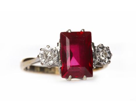 CREATED RUBY AND DIAMOND THREE STONE RINGthe central rectangular step cut created ruby flanked by two illusion set round diam