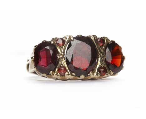 GARNET THREE STONE RINGset with three graduated oval garnets, hallmarks worn, size K, 3.9g