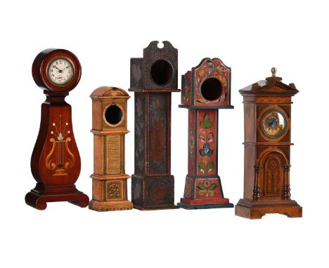 TWO MINIATURE LONGCASE TIMEPIECES AND THREE WATCH STANDS ALSO MODELLED AS MINIATURE LONGCASESINCLUDING ONE WITH A MOVEMENT BY