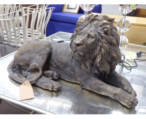RECUMBENT REGAL LION, 19th century style, faux bronze finish, 80cm x 35cm x 37cm approx. (slight faults)