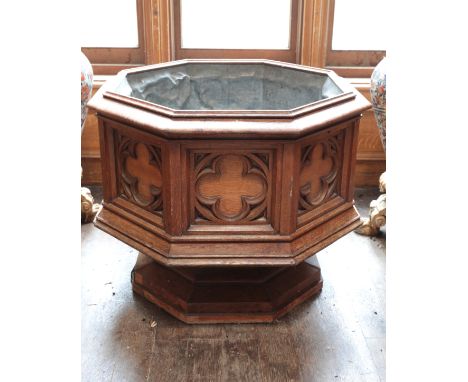 A WILLIAM IV OAK GOTHIC REVIVAL FONT the octagonal lead-lined basin with quatrefoil carved panelling, on a stepped plinth bas