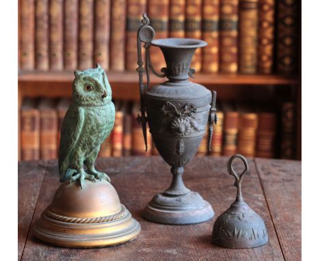 A PATINATED METAL FIGURAL INKWELLin the form of an owl, the head lifting back to reveal a reservoir, on a plinth base inscrib
