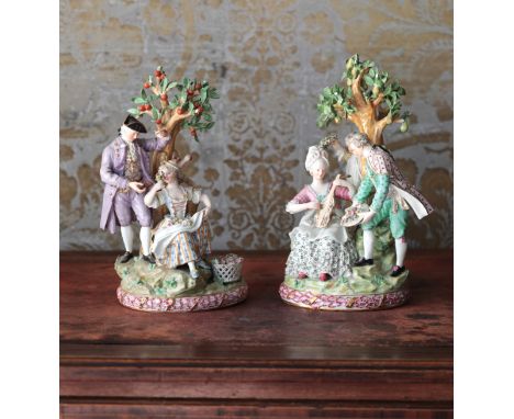 A PAIR OF MEISSEN PORCELAIN GROUPS OF LOVERS UNDER APPLE TREESbearing blue crossed swords marks to the base, one group modell