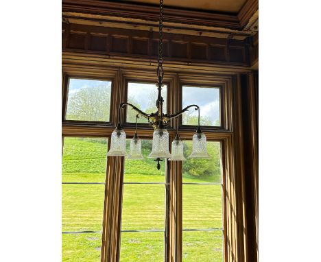 A REGENCY GILT METAL FIVE BRANCH CHANDELIER with five scrolled and acanthus leaf cast arms and suspended cut glass shades, ap